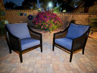 Set of 2 black aluminum Modern outdoor lounge chair with curved armrests and a perforated or mesh-style with blue cushions.