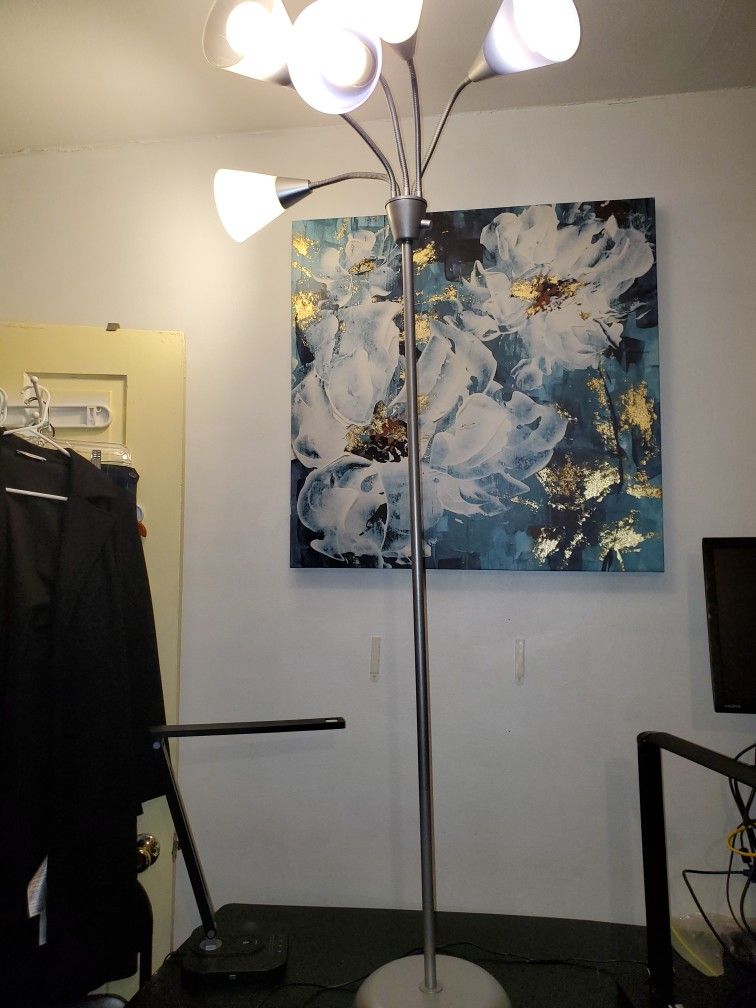 5-bulb floor lamp. This lamp has adjustable gooseneck arms, allowing you to direct the light where needed. It has a modern design and is in white, b