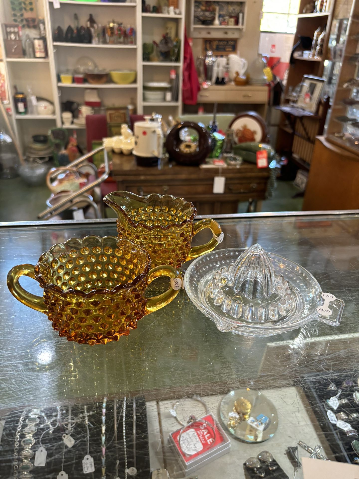 7x3 amber hobnail cream and sugar 18.00. 6.5 Hobnail glass juicer 14.00.  Johanna at Antiques and More. Located at 316b Main Street Buda. Antiques vin