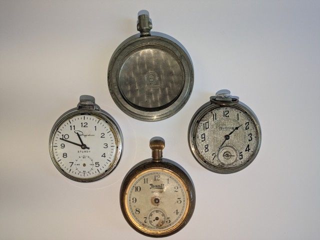 Collection of 4 antique pocket watch items as pictured. Late 1800s early 1900s. One is a partial case only, made of Silverode. All not working 
