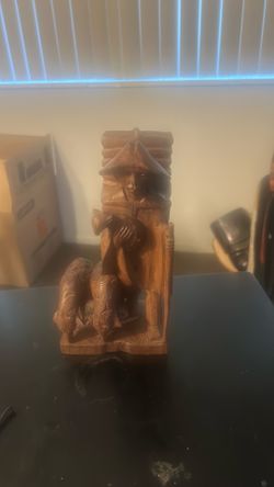The selected region highlights a vintage hand-carved wooden figurine of a shepherd