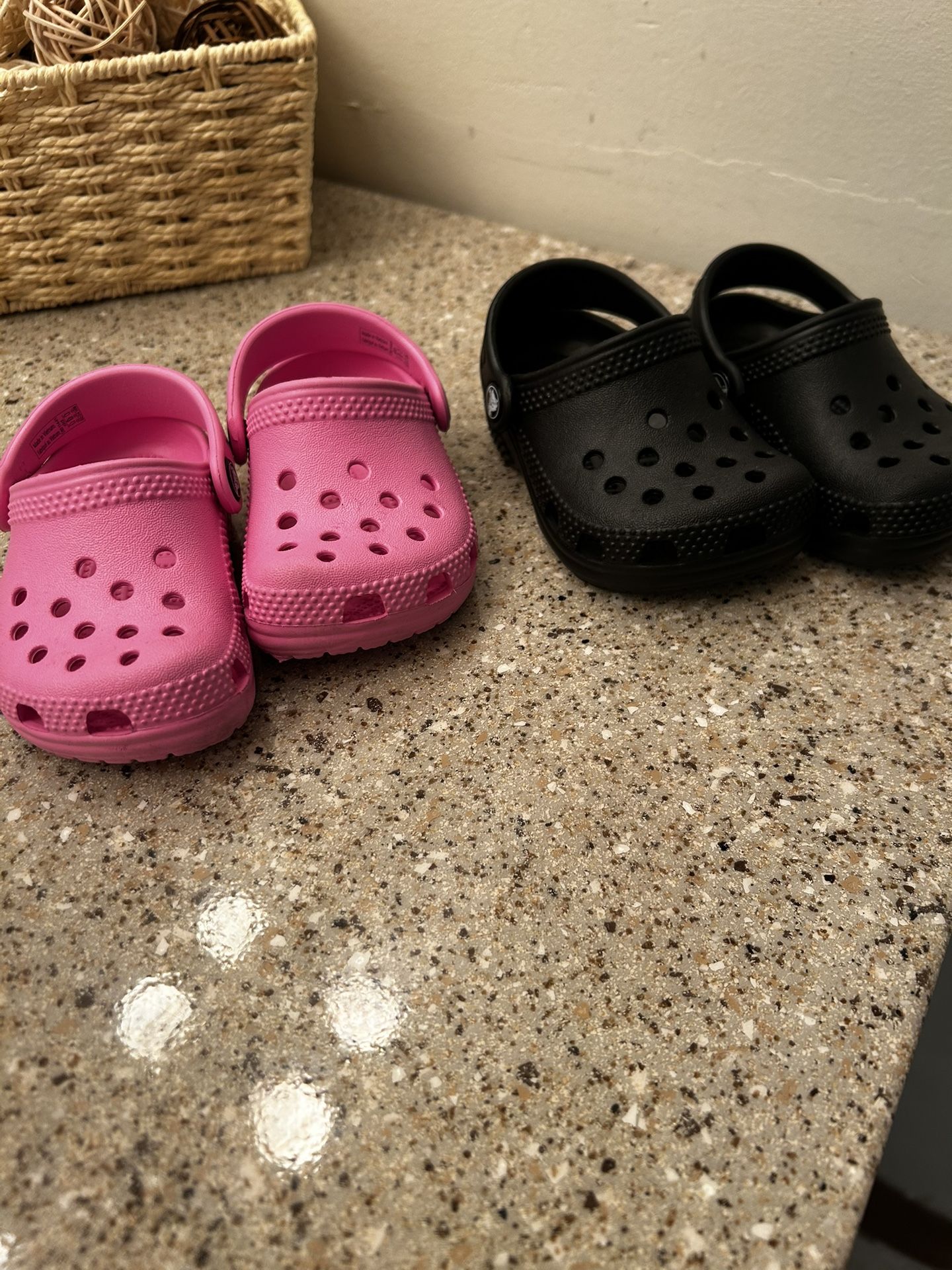 Black Pair And Pink Pair Of Kids Crocs