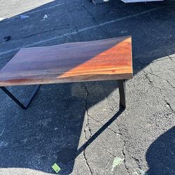 wood coffee table with modern black metal legs.  