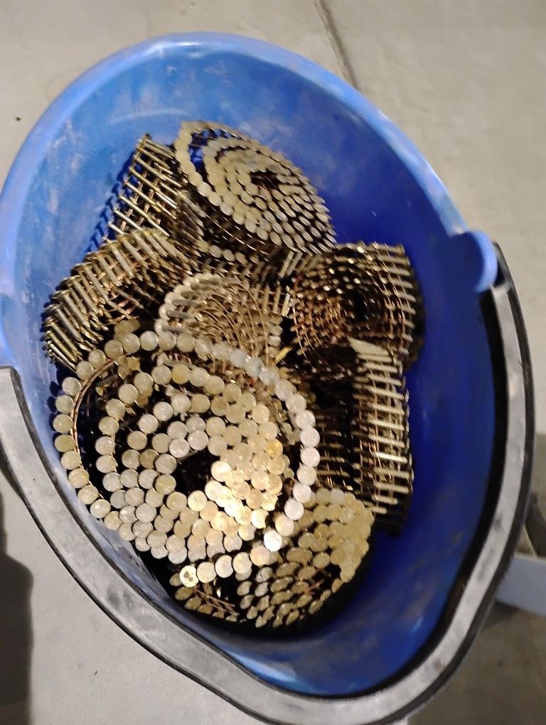 Bucket Of Roofing Nail Rolls For A Nail Gun