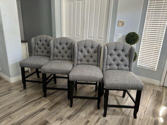 Four beautiful gray tufted counter Height bar stools