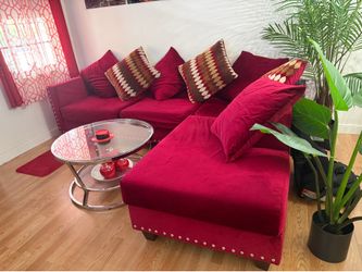 L shaped burgundy couch with round coffee table