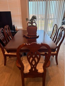 Dark cherry wooden table with leaf and 6 chairs white upholstery