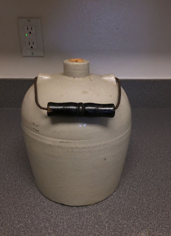 Vintage one gallon jug with wire and wood handle for Sale in Huntsville