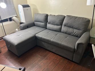 L-shaped gray sofa with storage ottoman