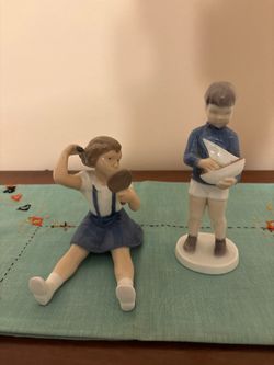 Two figurines are highly collectible Danish porcelain pieces made by Bing & Grøndahl