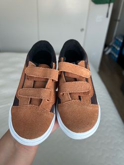 Brown toddler Vans shows