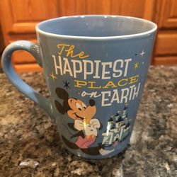 Disney “The Happiest Place On Earth” Disneyland 65th Anniversary Coffee Cup. Size 4 1/4 inches tall and 3 1/2, inches wide across the rim.  Brand New 