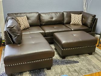 luxurious espresso faux leather sofa with nailhead trim and ottoman!
