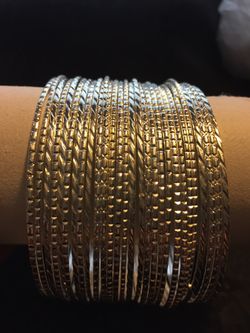 Stacked bright silver bangles