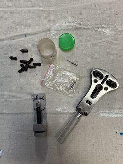 Watch repair kit specifically designed for replacing watch batteries and resizing metal bracelets. It contains tools meant for distinct tasks: