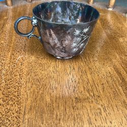 This is likely a vintage or antique silver-plated cup, which appears to be a mustache cup based on similar items found in searches. These were popular