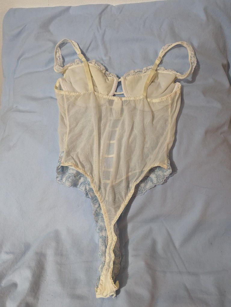 
Victoria Secret pale blue and white/cream Teddy Size: 36 C  adjustable shoulder straps Crotch area has snap closure See-through lace on the front and