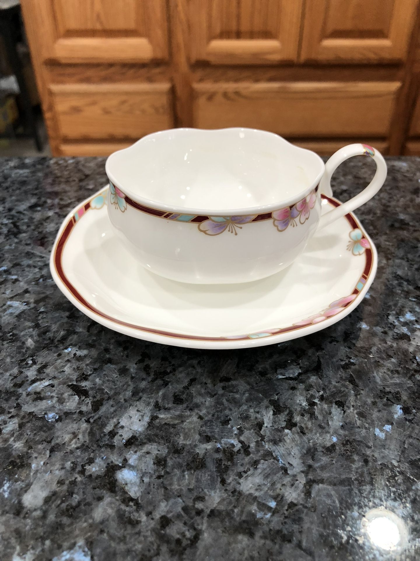Rare bone China Korea Floral rim tea cup and saucer.  Floral rim Design - shallow cup. Korea . Approximate 1 3/4" tall and 5" across at the handle. Th