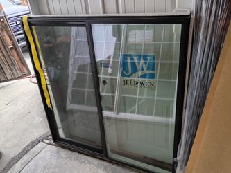 57 1/2". X. 57. New construction window dark brown outside white inside available now