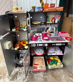 KidKraft wooden kitchen with 240 accessories—all solid wood.
