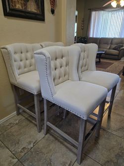 4 Homcom upholstered tufted wingback counter height bar stools with nail heads