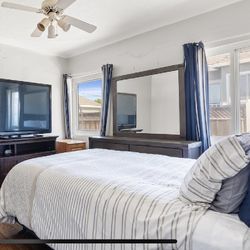 Tv, Dresser, And Bed With Headboard And Mattress