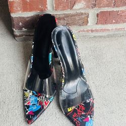 Pointed-toe stiletto pumps with clear vinyl uppers and a colorful graffiti print on the toe and heel areas, such as the Onlymaker Graffiti Colorful St