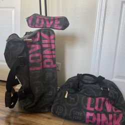 Pink Victoria’s Secret 3 piece rolling luggage set.
