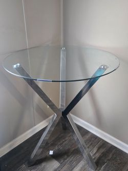 Glass top table aprox 4 ft high
