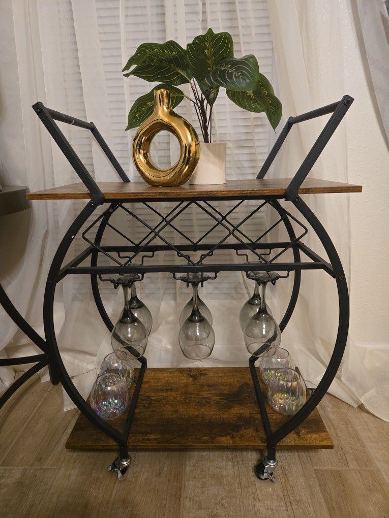 Stylish bar cart with wood shelves and metal frame.