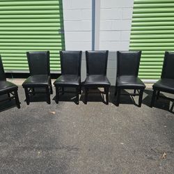 Six real wood and leather mahogany chairs.
