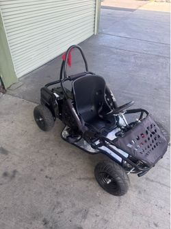 Awesome Go-Bowen go-kart. Black frame with a comfy seat. Has seatbelt for safety. Metal diamond plate footrests. Red safety flag on the back. Tires lo