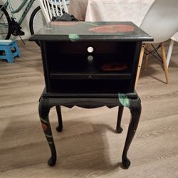 black nightstand with flower pattern