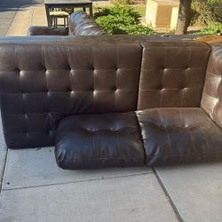 Leather Couch And Table With Three Chairs