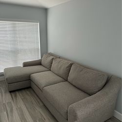 Harvey’s sectional sofa with chaise in a gray fabric