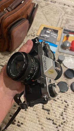 vintage Canon AE-1 Program 35mm SLR Film Camera set with lens, zoom, flash & bag