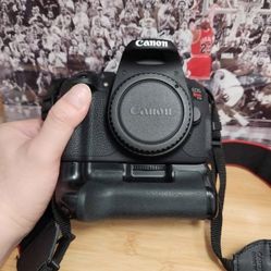 Canon EOS Rebel T5i DSLR Camera with 18-55mm Lens
Comes with battery, charger,  strap and battery grip