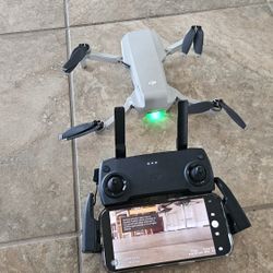 DJI Mavic Mini drone, comes with a battery, controller, cable connect to control and spare propellers.