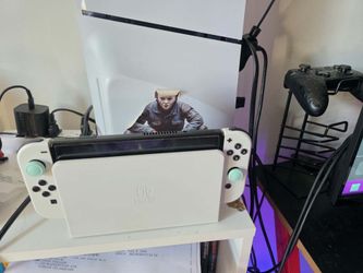 nintendo switch oled with 256 sd card and a pro controller