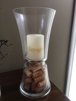 Glass candle holder with decorative wine corks in the base..14” tall and 6.5” diameter