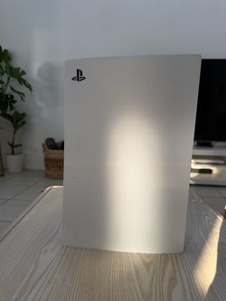 PS5 with games, controller and power cord.