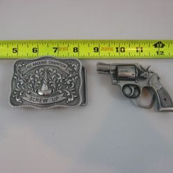 2 1970's " All Around Champion Screw Up & Pistol Revolver Belt Buckles

