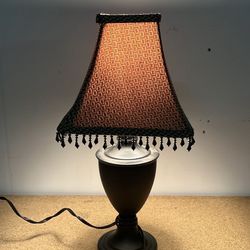 Cute table lamp with dark base and beaded shade