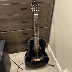Black yamaha acoustic guitar