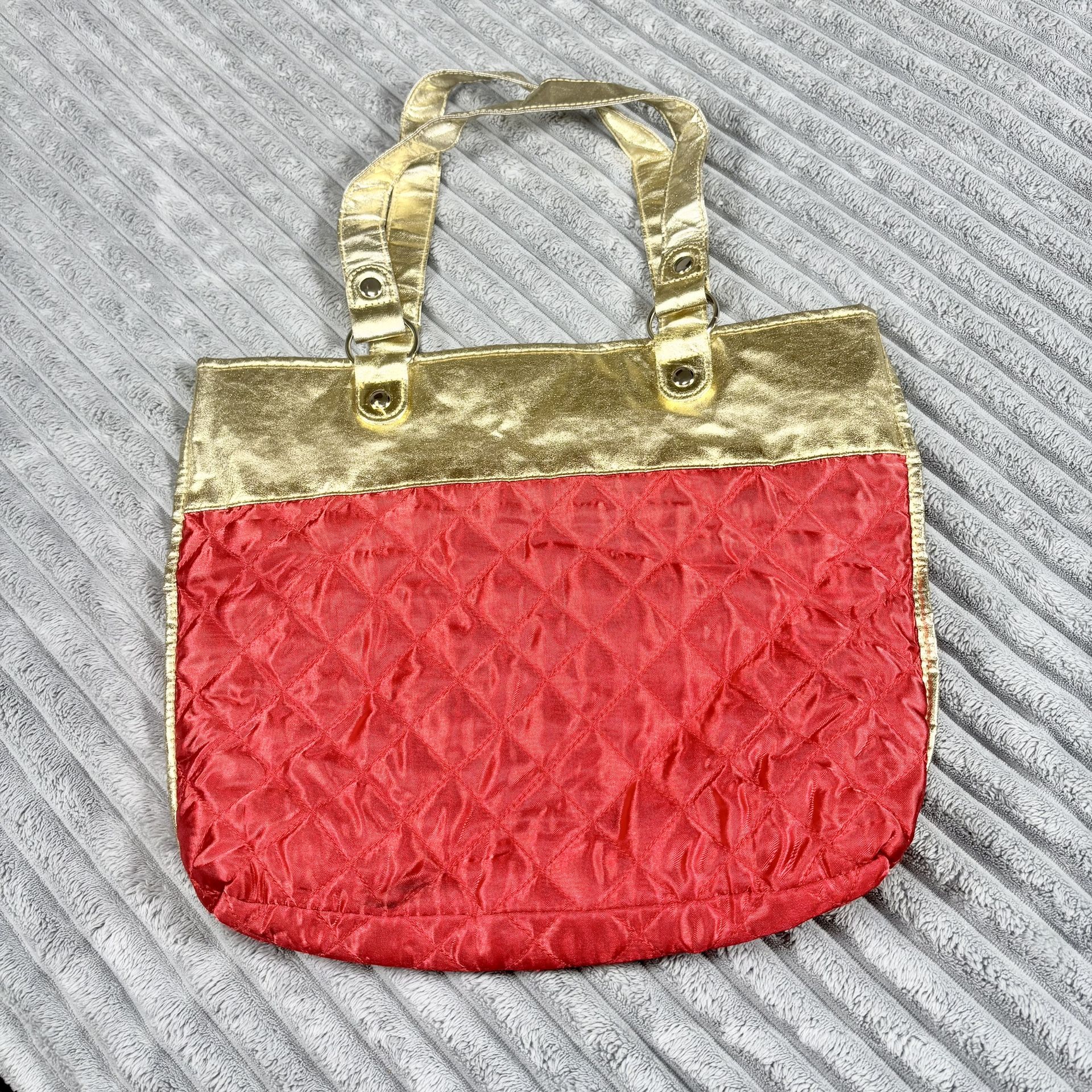 Women’s red quilted tote bag with gold trim trimming