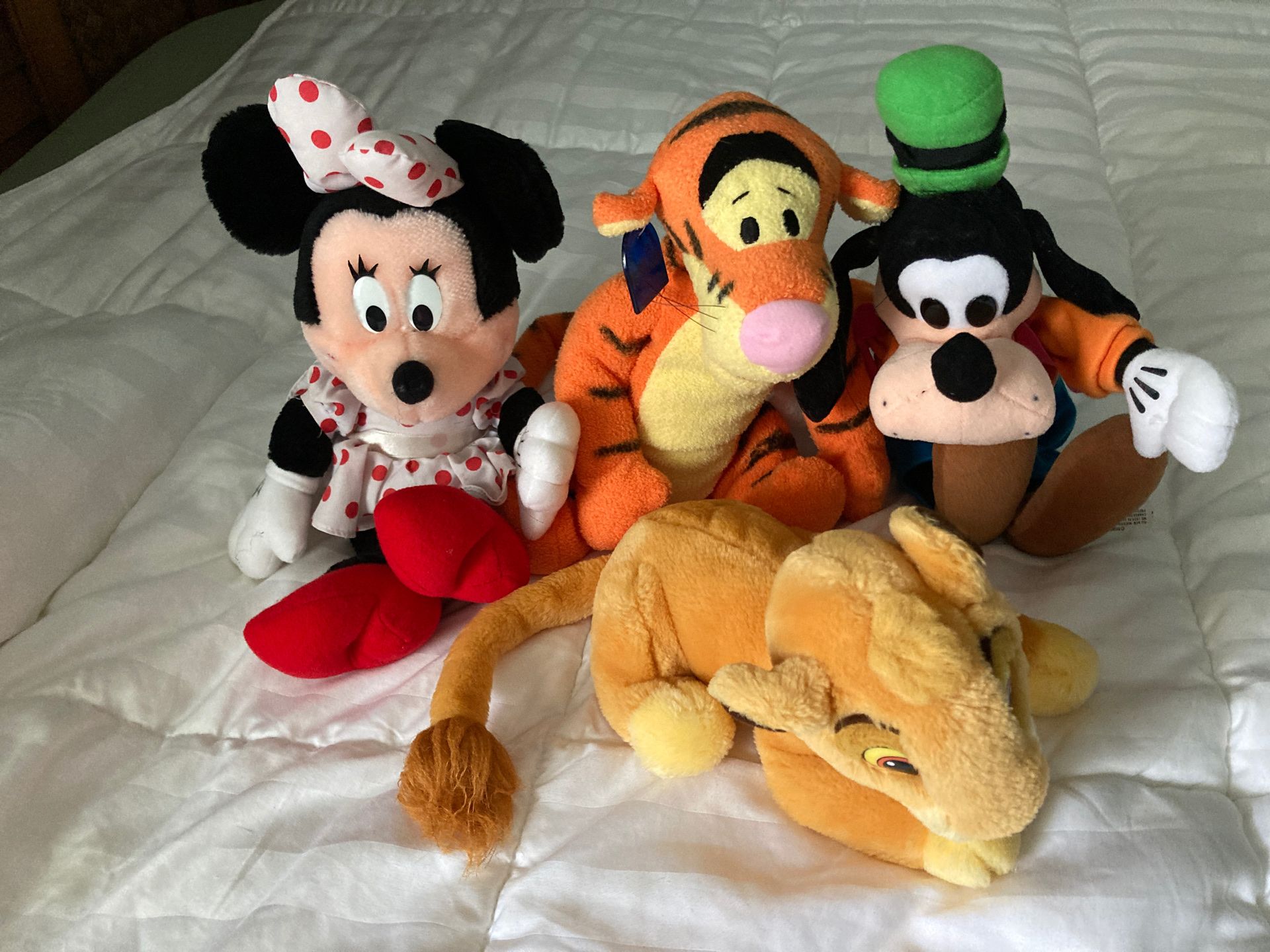 Four Disney stuffed animals