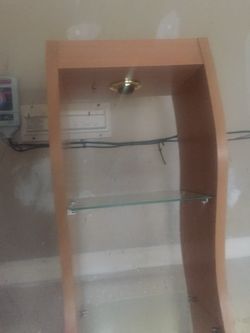 Wood cabinet with glass shelves and light