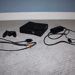 Black Xbox 360 with controller and games