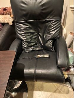 Black leather massage chair with leg rest