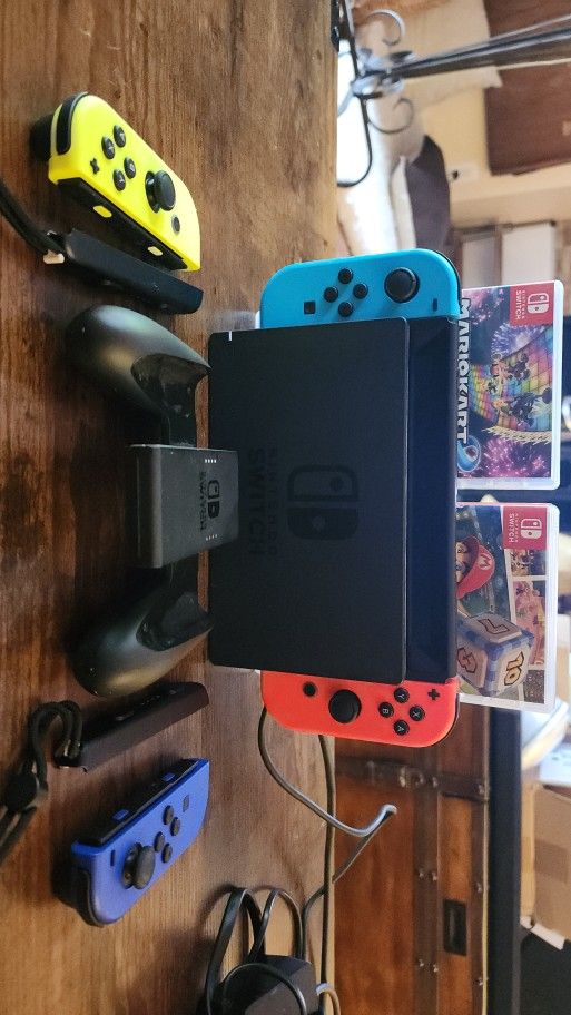 Nintendo Switch With 4 Controllers /2 Games (Mario Kart 8 Deluxe & Mario Party Superstars) / Game Controller Attachment / Remote Straps.  HDMI, And Po